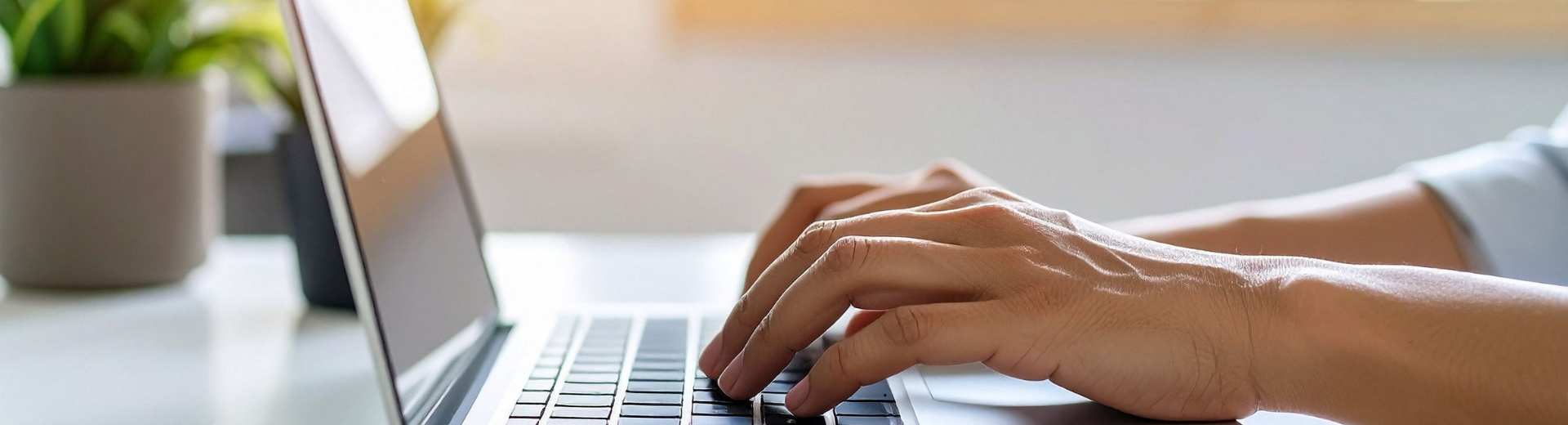 Hands typing on a laptop 